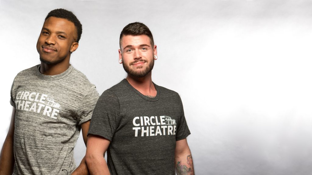 Two men wearing Circle Theatre T-shirts in light gray and dark gray.