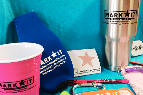 Promotional products for MarkIt Merchandise with tumbler, koozie, notepads, bottle openers, band-aids and pens.