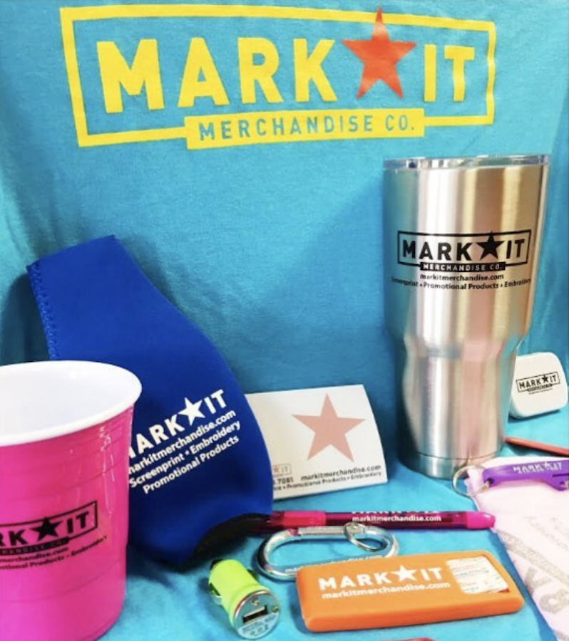 MarkIt Merchandise swag: koozies, stainless steel cup, notepads, pens, and bandaids.
