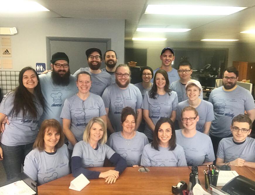 Group of co-workers dressed in matching shirts.