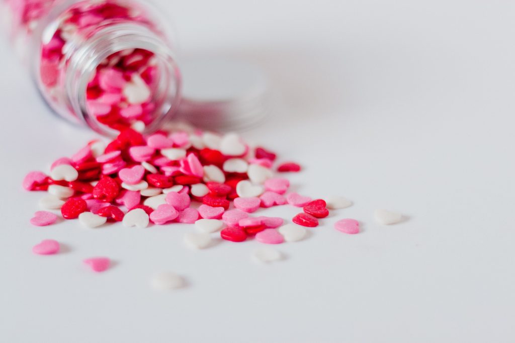 Candy heart sprinkles being tipped over, featured in MarkIt Merchandise's blog post.