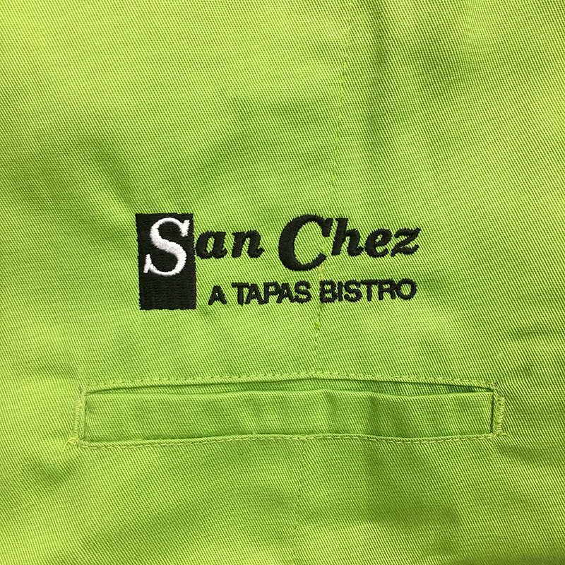 San Chez A Tapas Bistro Embroidery on lime green chef coat. Embroidered at MarkIt Merchandise.