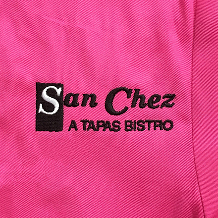 Black San Chez A Tapas Bistro on bright pink.